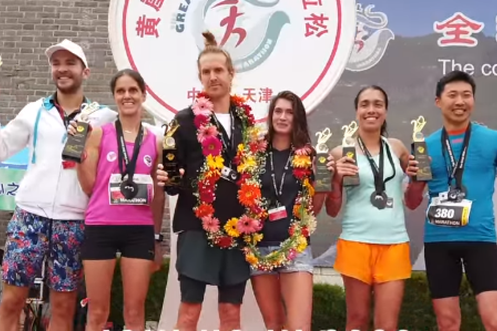 Douglas Wilson and Kali Cavey (centre pair) celebrate winning the Great Wall Marathon. Photo: Adventure Albatross Marathons
