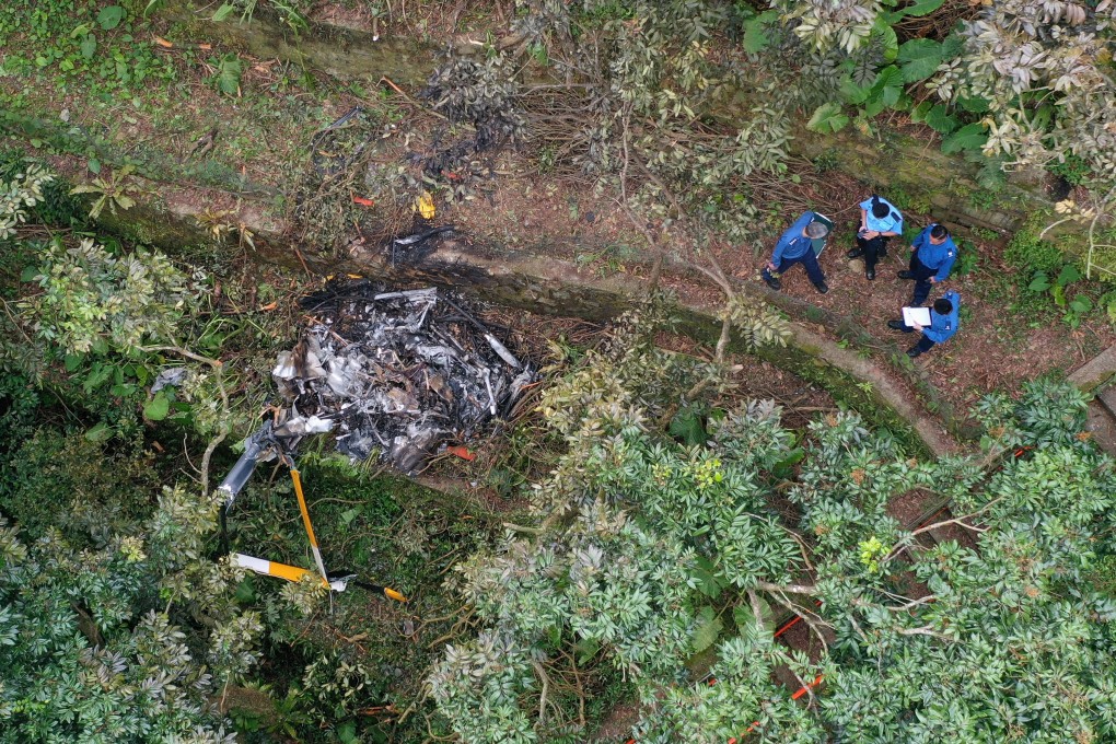 Accident investigators stand near the wreckage of the helicopter near to Kadoorie Farm in Pat Heung, Yuen Long. Photo: Winson Wong