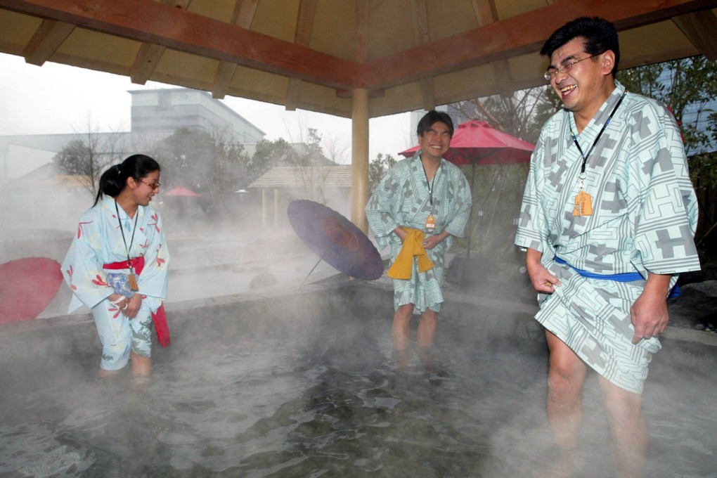Visitors warm their feet at a hot-spring spa complex built on a man-made island in Tokyo Bay. Investment funds are buying into Japan’s spa business. Photo: AP