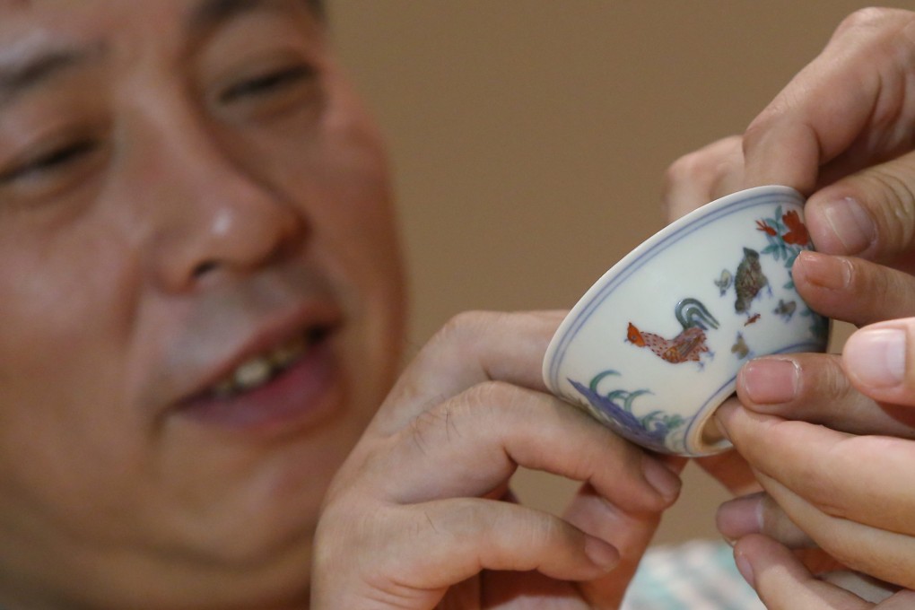 Collector Liu Yiqian shows the Meiyintang “chicken cup” from the Ming dynasty that he bought at a Sotheby's action in July 2014. Photo: AP