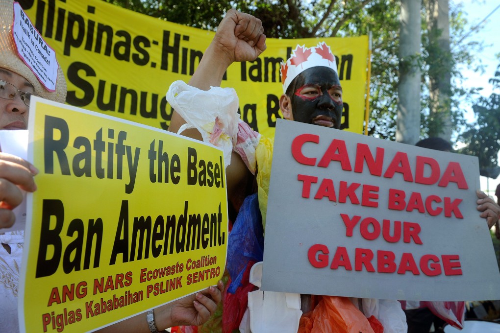 Environmental activists rallying outside the Philippine Senate to demand containers filled with household rubbish be shipped back to Canada. Photo: AFP