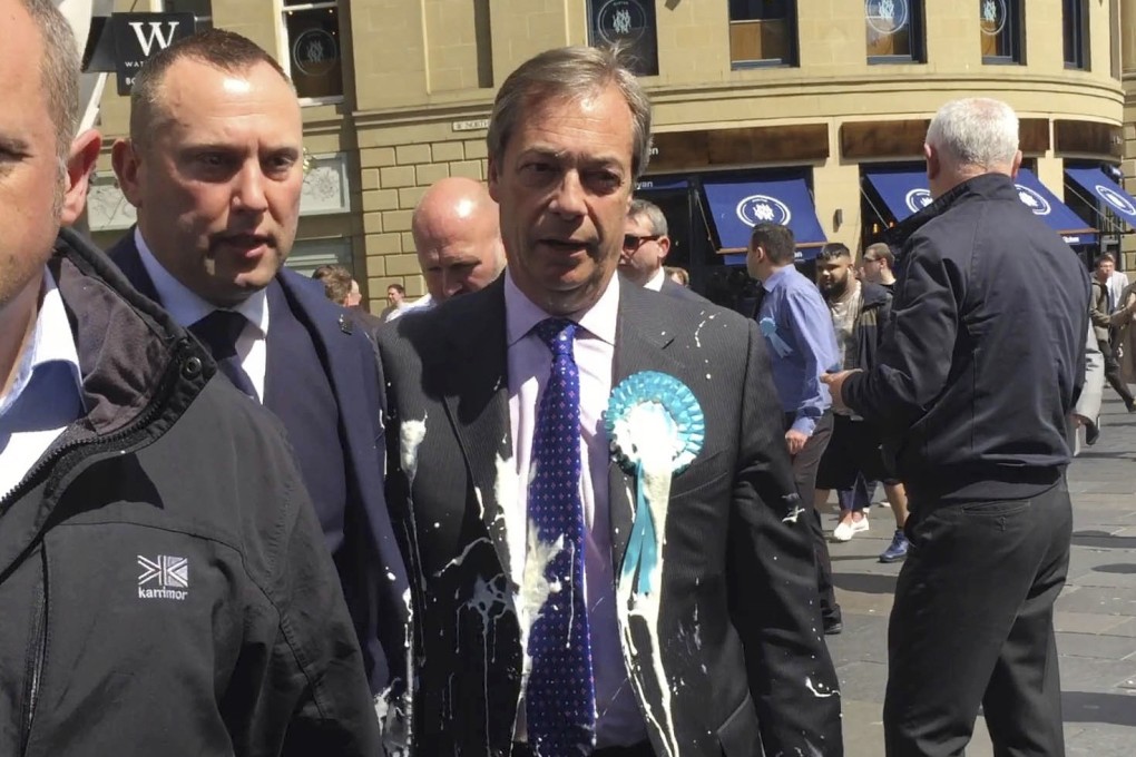 Brexit Party leader Nigel Farage after being hit with a milkshake during a campaign walkabout for the upcoming European elections in Newcastle, England on Monday. Photo: PA via AP