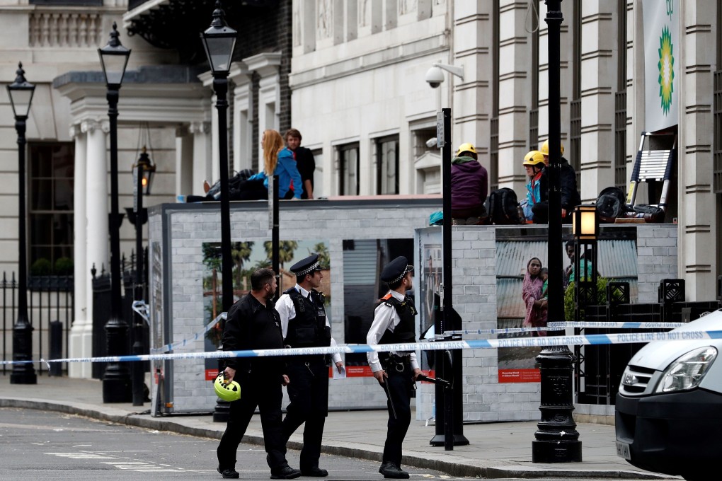 Activists from the environmental action group Greenpeace blocked the entrance to BP headquarters in central London. Photo: AFP