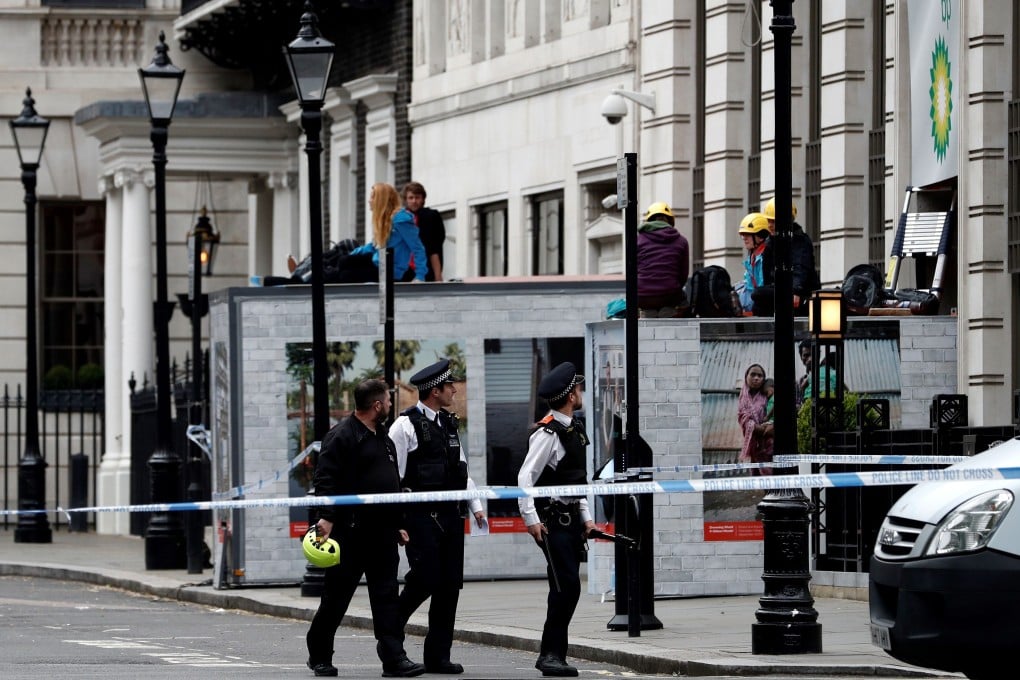 Activists from the environmental action group Greenpeace blocked the entrance to BP headquarters in central London. Photo: AFP