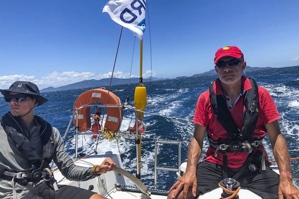 The Grelons – Cosmas (left) and father Philippe – sail their boat Decathlon Aya through the Verde Island Passage in Philippine waters. Most races they enter have boats crewed by up to 10 people. Photo: Courtesy of Phillipe Grelon.