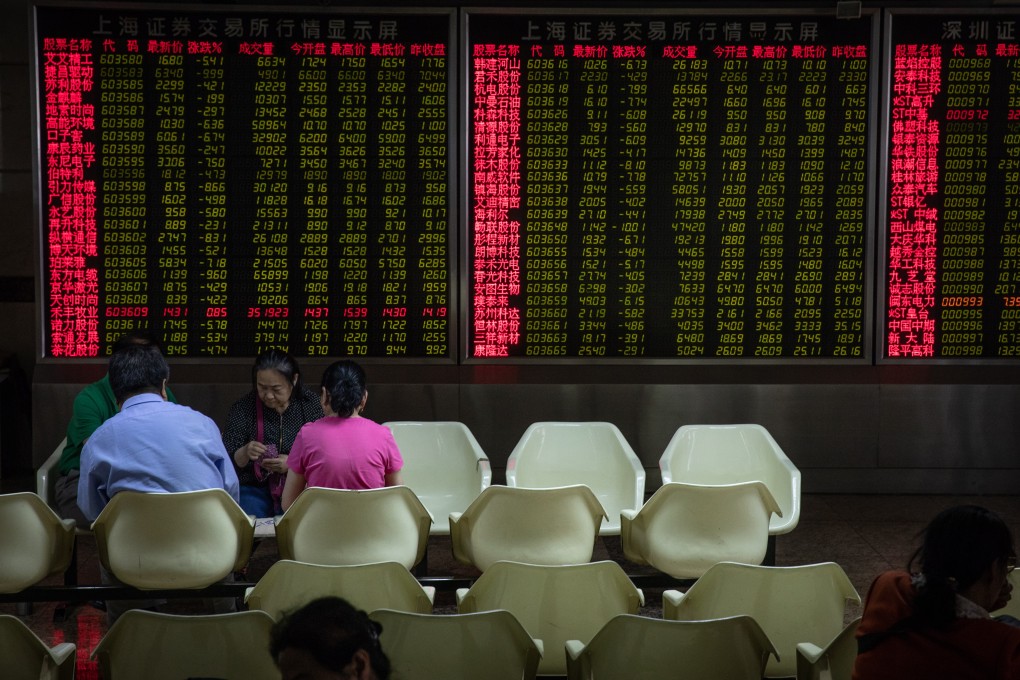 Chinese investors play cards next to an electronic board displaying the stock index and prices at a securities brokerage in Beijing in May 6. Photo: EPA-EFE