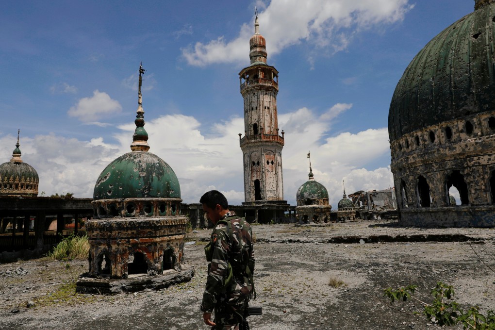 A soldier on the rooftop of the war-torn Grand Mosque in Marawi City. Photo: Reuters
