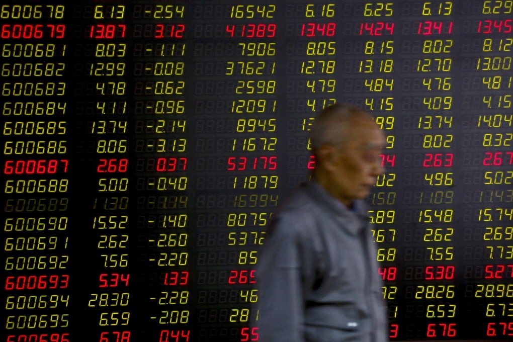 In this May 14, 2019, a man walks past an electric board displaying stock prices at a brokerage house in Beijing. Photo: Associated Press