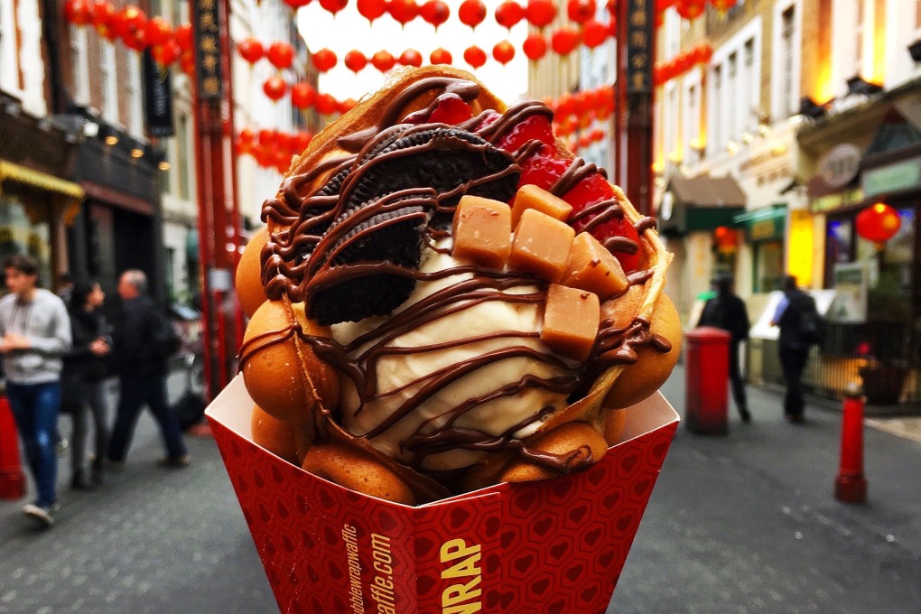 Preparing to eat a Bubblewrap waffle in London’s Chinatown. Two young entrepreneurs from China have turned the humble Hong Kong egg waffle into an opulent dessert.