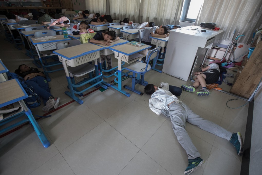 Primary school pupils take a break during “Noon Nap Class”, in the city of Hangzhou, in China’s Zhejiang province. Photo: Imaginechina