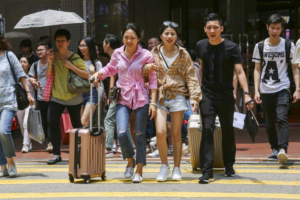 Mainland tourists go out shopping in Tsim Sha Tsui on Labour Day, at the start of the four-day mini-Golden Week holiday in May. But service standards are likely to be much better back home. Photo: Jonathan Wong