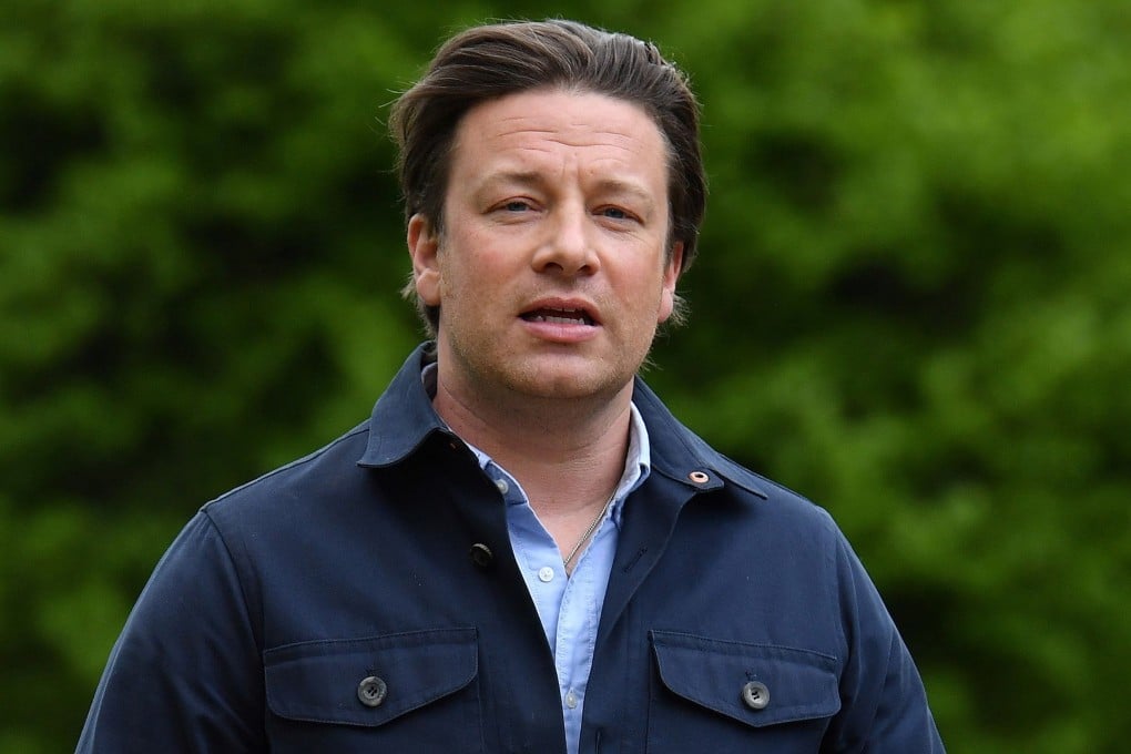 British chef and activist Jamie Oliver arrives to speak to members of the media after speaking on the subject of childhood obesity to a parliamentary committee. Photo: Ben Stansall/AFP
