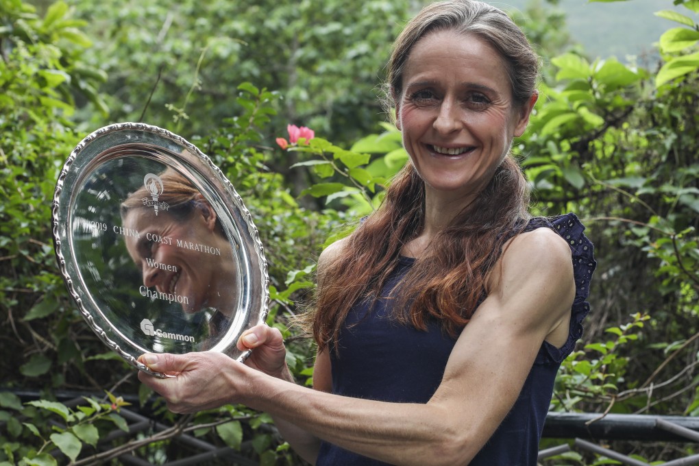 Marathon runner, cancer survivor and mother of five children Amy Mumford shows off a recent race trophy. Having breast cancer taught her the power of positive thinking, she says. Photo: Xiaomei Chen