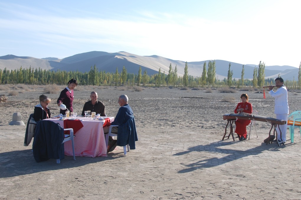 Serenaded by local musicians, wealthy visitors enjoy a private banquet in the Gobi Dessert. Photo: Guy Rubin