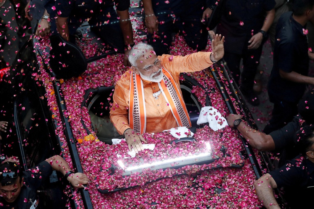 Indian Prime Minister Narendra Modi waves to supporters in Varanasi. Photo: Reuters