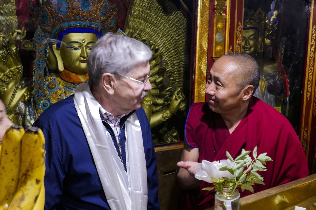 US ambassador to China Terry Branstad (left) speaks to a monk at Jokhang Temple in Lhasa in the Tibet autonomous region. The U.S. ambassador to China urged Beijing to engage in substantive dialogue with exiled Tibetan Buddhist leader the Dalai Lama during a visit to the Himalayan region over the past week, the Embassy said Saturday. (U.S. Mission to China via AP)