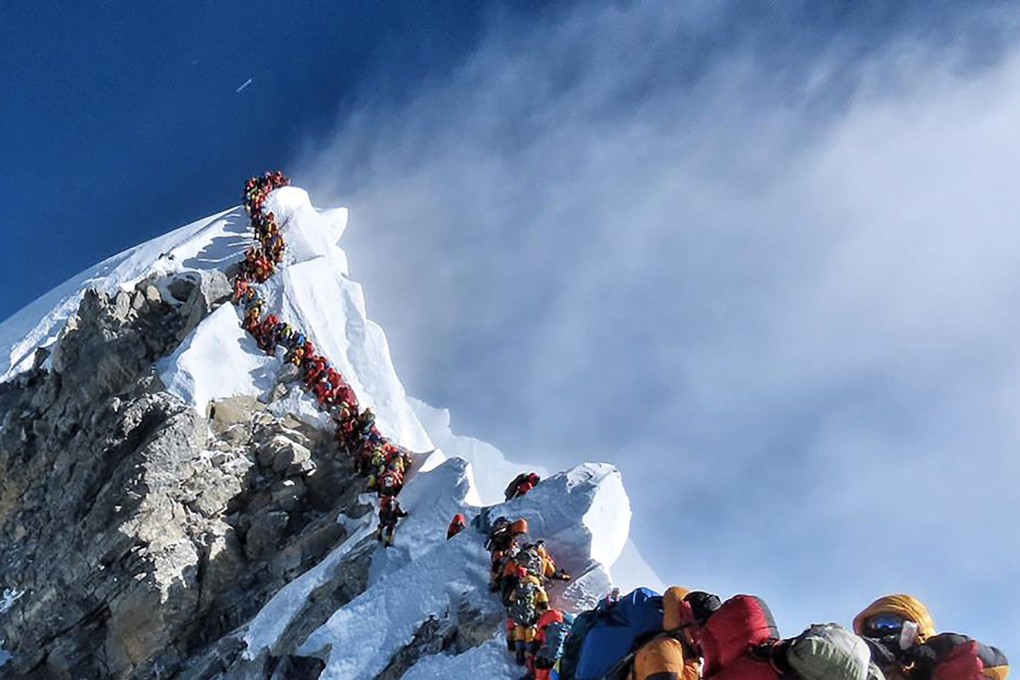 Mountain climbers queuing up to stand on the summit of Mount Everest. The heavy traffic led to delays with climbers risking frostbites and altitude sickness. Photo: AFP/Project Possible