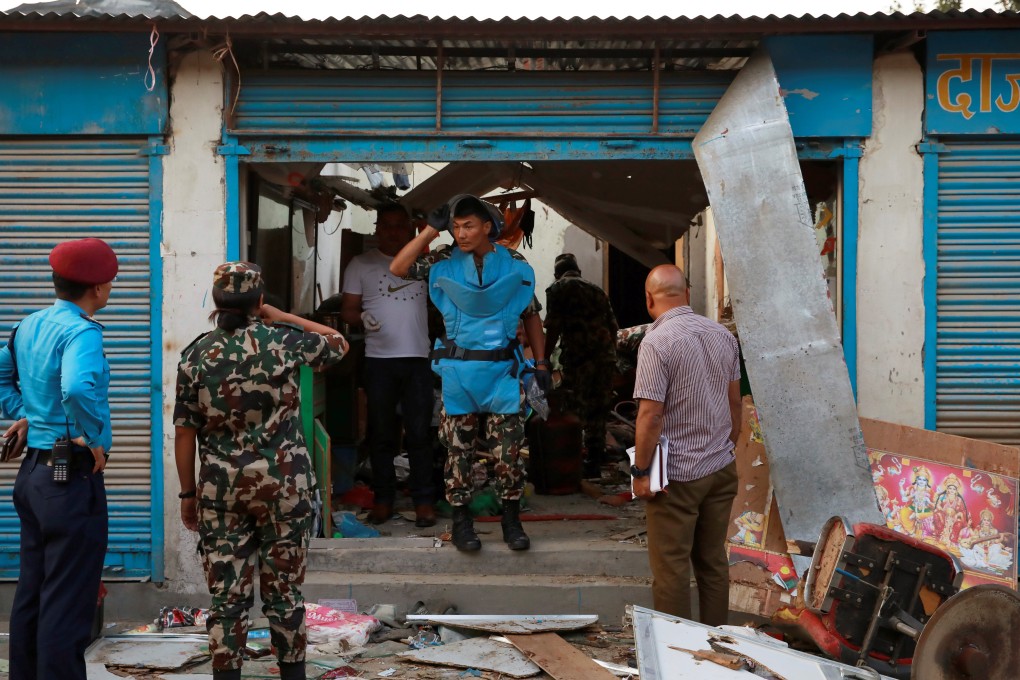 Security personnel inspect an explosion site in Kathmandu, Nepal, on Saturday. Photo: Reuters
