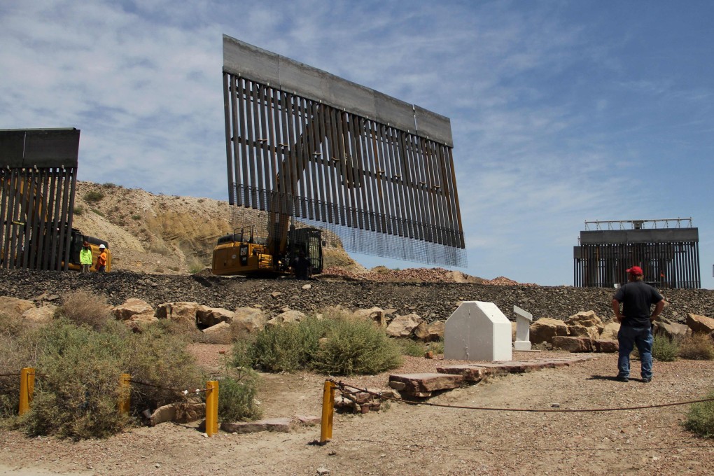 Workers build a border fence on a private property at the US-Mexico border on Sunday. Photo: AFP
