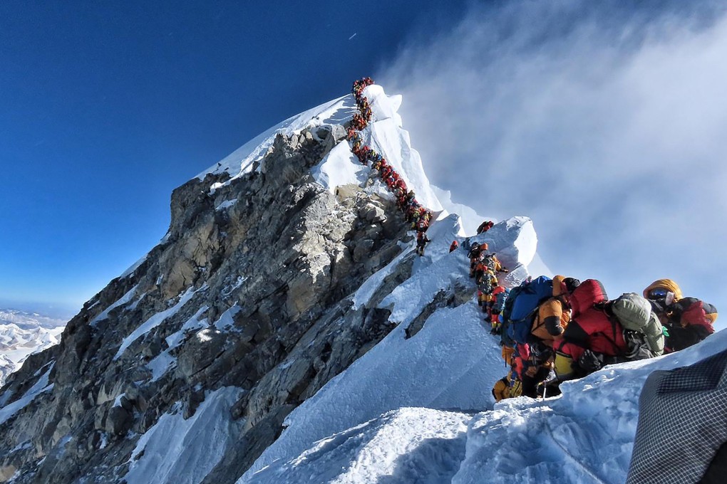 This startling photograph of a human traffic jam that stranded climbers for hours on a ridge below the summit of Mt Everest illustrate a disaster waiting to happen. Photo: AFP Photo / Project Possible