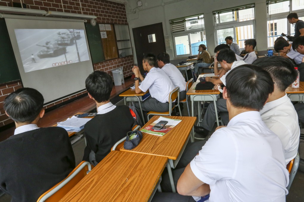 The Form Five maths class of teacher Peter Lee watch footage of the events in Tiananmen Square 30 years ago. Photo: Jonathan Wong