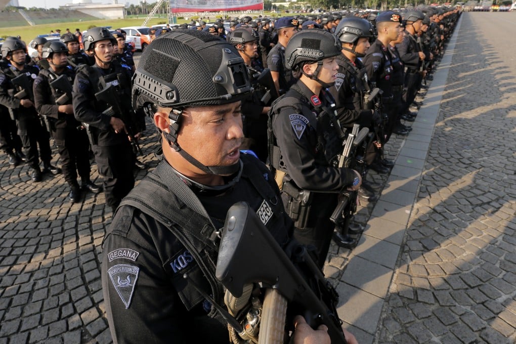 Police officers stand in attention during a show of force on Tuesday in Jakarta. Photo: AP