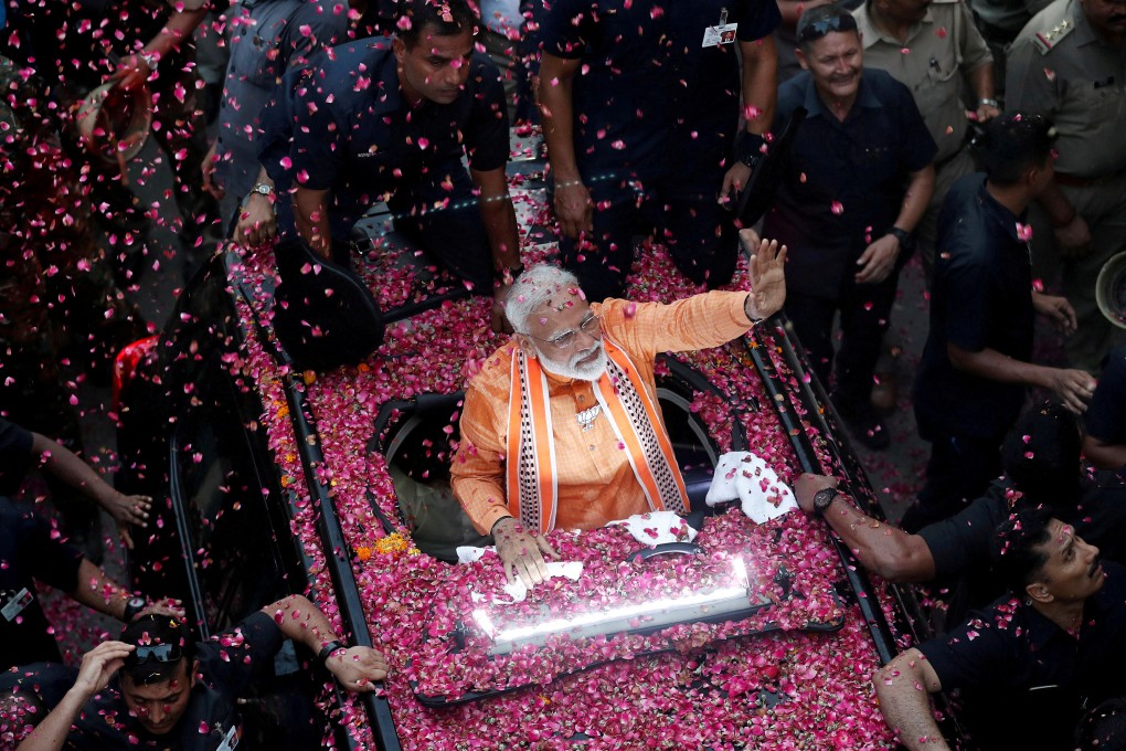 Indian Prime Minister Narendra Modi greets supporters during a roadshow in his constituency of Varanasi on April 25. On May 23, he returned to power with a resounding mandate, as the BJP became the first party in 30 years to win an outright majority in Indian parliamentary elections. Photo: Reuters