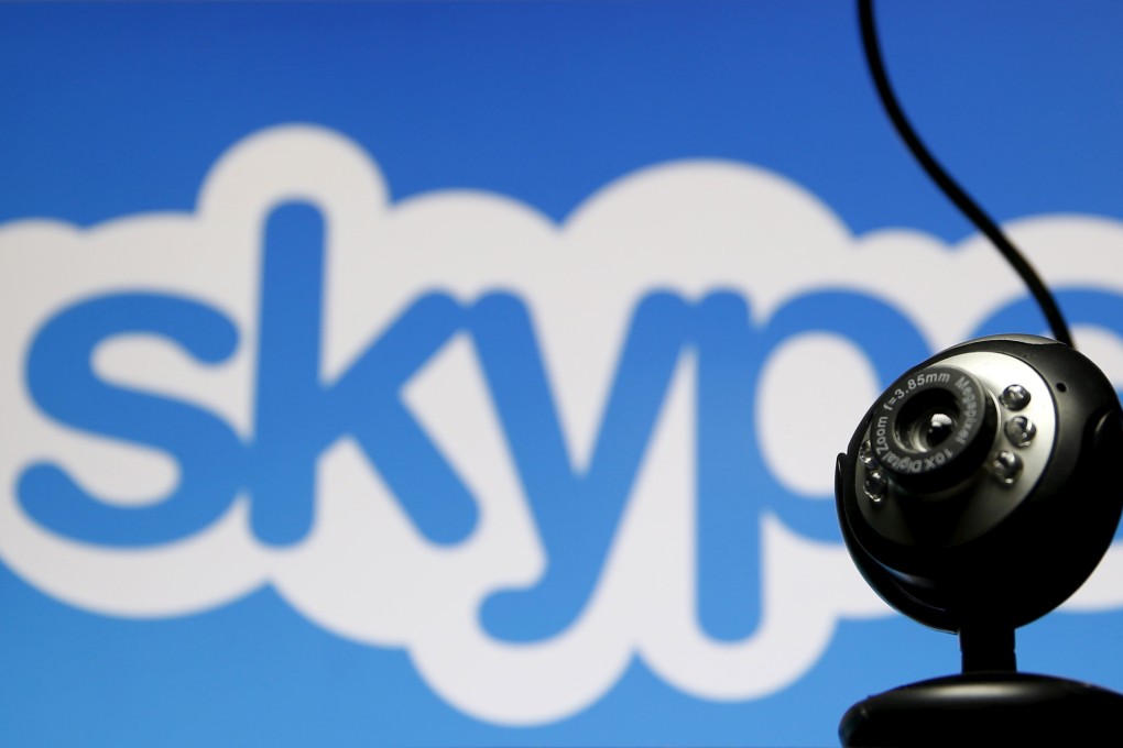 A web camera in front of the Skype logo. Photo: Reuters