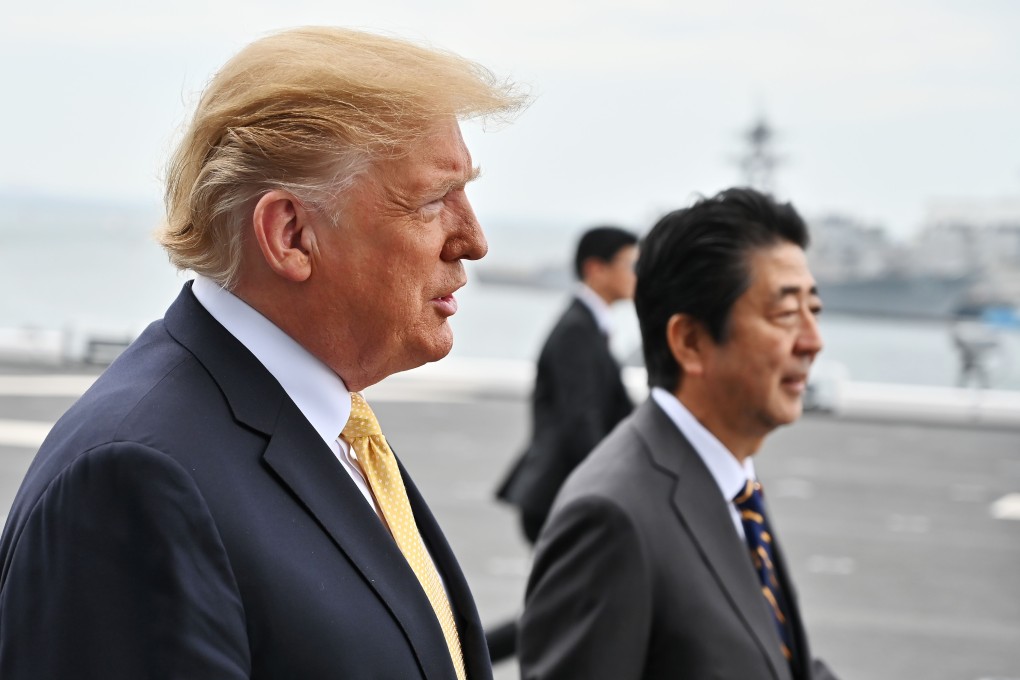 US President Donald Trump boards helicopter carrier the JS Kaga with Japanese Prime Minister Shinzo Abe on Tuesday. Photo: AFP