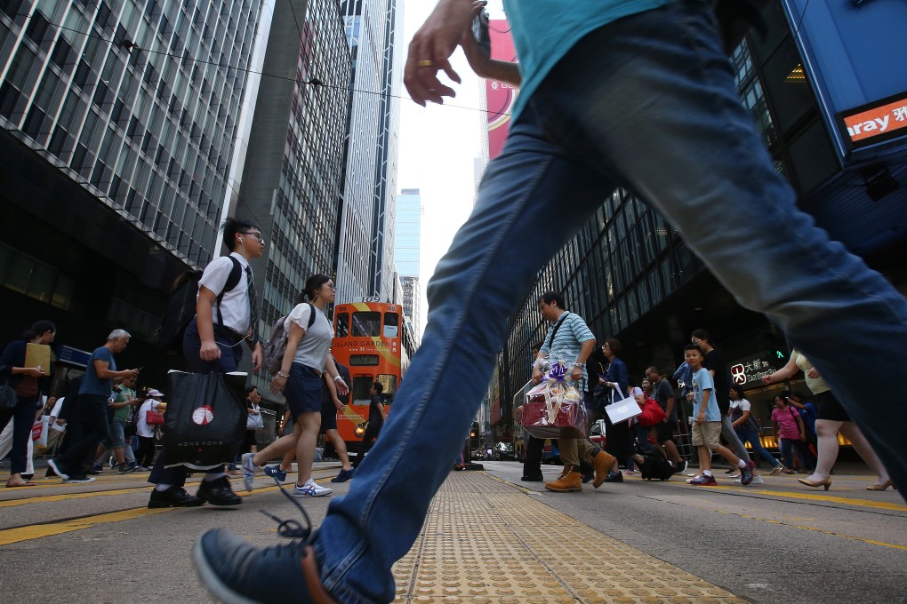 A pedestrian crosses the street in Central, one of the districts targeted for walkability trials. Photo: K. Y. Cheng