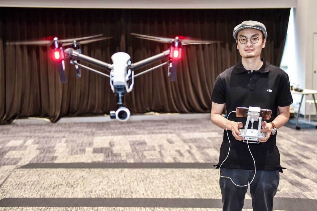 Frank Wang Tao, founder of SZ DJI Technology, controls a drone at the company’s offices in Shenzhen on May 22, 2015. Photo: Xinhua