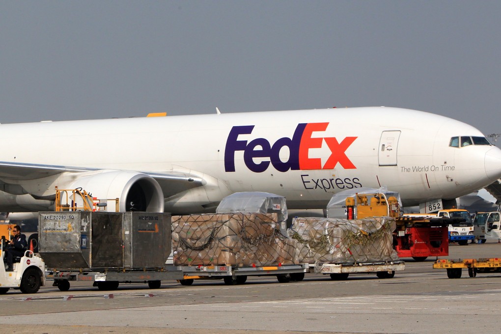 A FedEx cargo aircraft is seen parked at a gate near the FedEx facility at the Hong Kong International Airport. Photo: Jonathan Wong