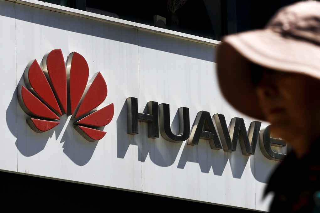 A woman walks by a Huawei retail store in Beijing on Wednesday. Photo: AP