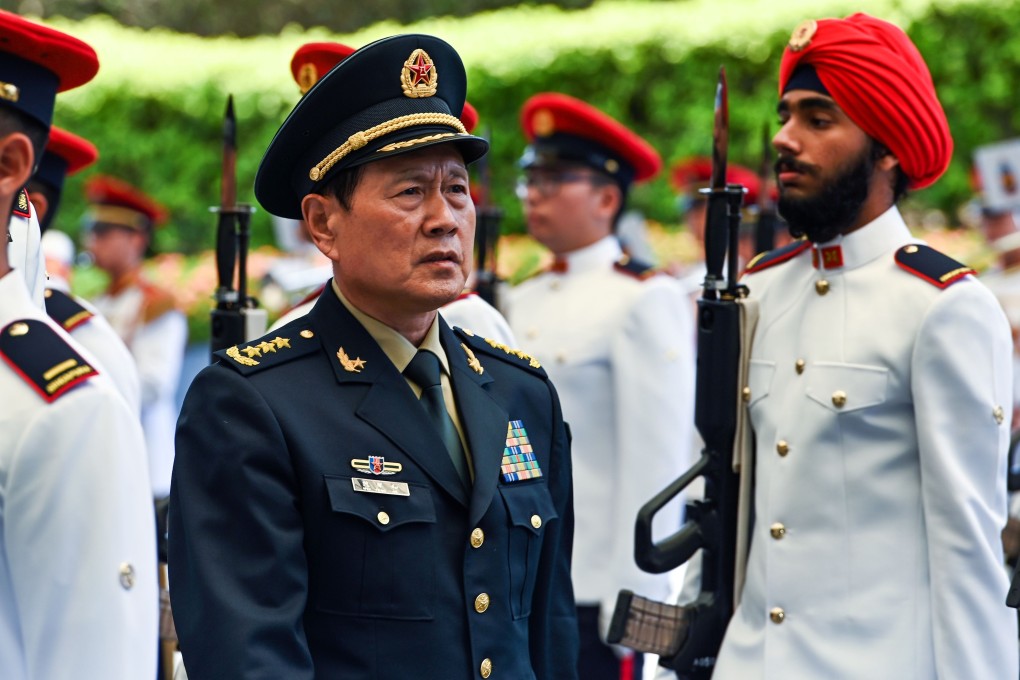 Chinese Defence Minister General Wei Fenghe inspects the guard of honour during a welcome ceremony in Singapore on Wednesday. Photo: AFP