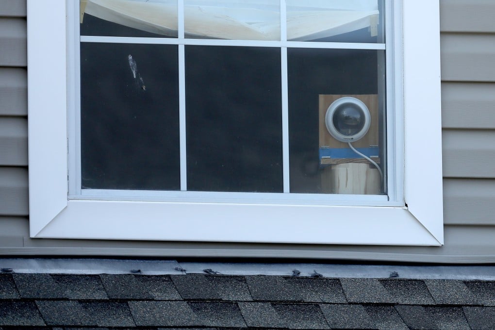 A video camera in the second-floor window of suspected gunman DeWayne Craddock's flat. Photo: AFP