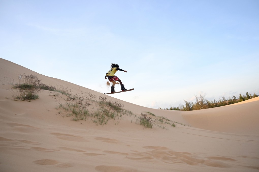 Vietnamese snowboarder Nguyen Thai Binh gets some air at the sand dunes near Mui Ne in southern Vietnam. Photo: Manan Vatsyayana/AFP