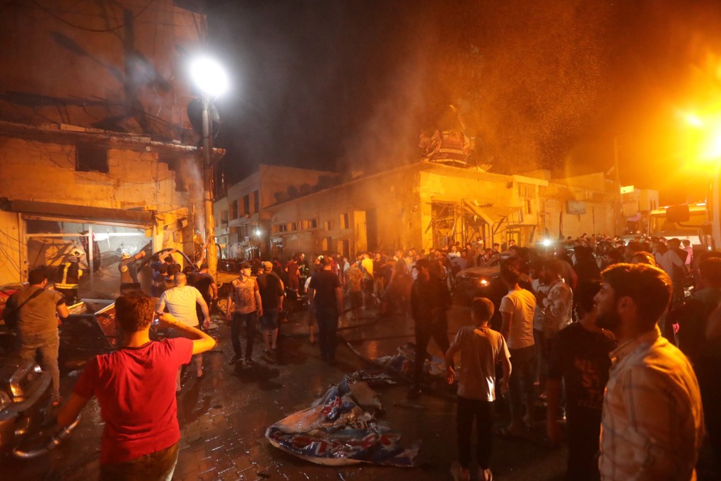 People gather at the site of a car bomb blast in Azaz. Photo: Reuters