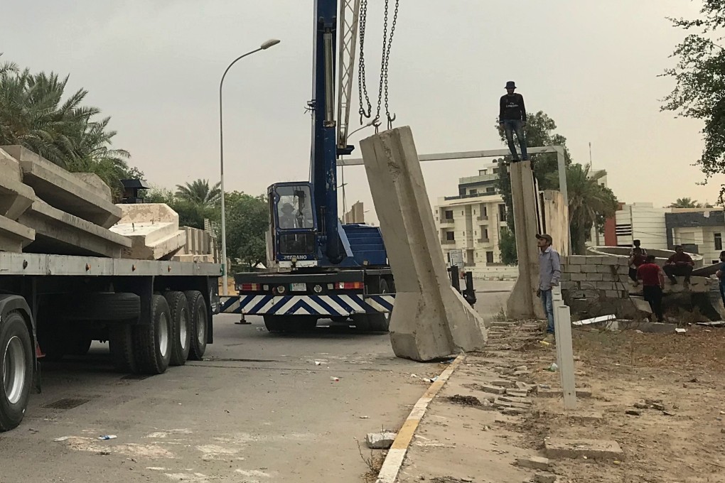 Iraqi security forces remove concrete blast walls at the Green Zone in Baghdad. Photo: AP