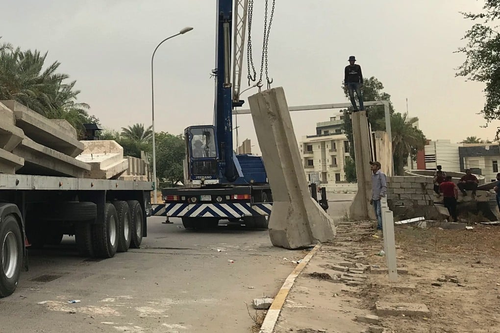 Iraqi security forces remove concrete blast walls at the Green Zone in Baghdad. Photo: AP