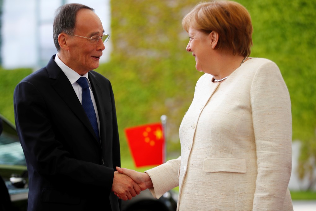 German Chancellor Angela Merkel welcomes Chinese Vice-President Wang Qishan in Berlin on Friday. Photo: Reuters