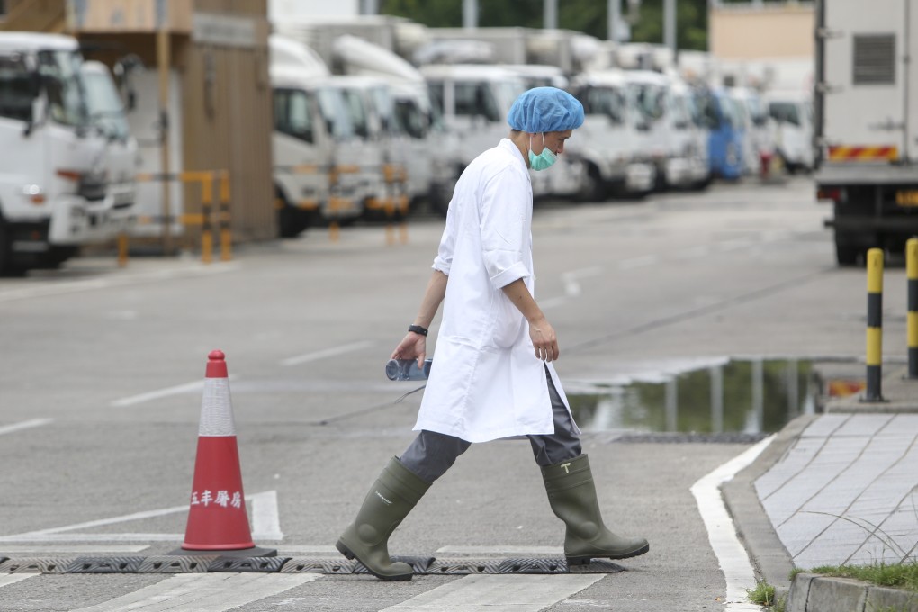 An employee dressed in protective clothing walks through the Sheung Shui facility. Photo: Winson Wong