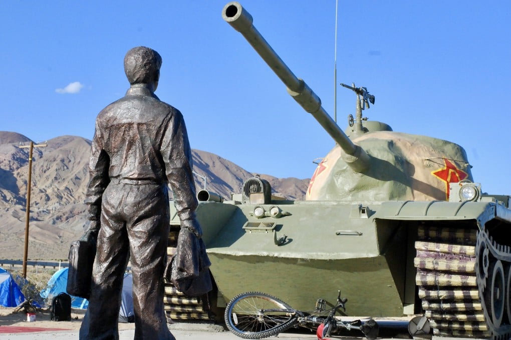 Chen Weiming’s statue stands with a rendering of a Chinese tank in a sculpture park in Yermo, California. Photo: Eileen Guo