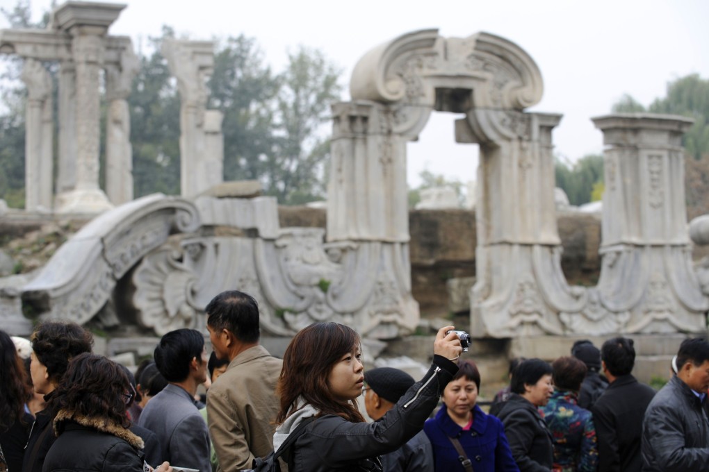 Visitors at the ruins of the old summer palace in Beijing that was burned by British and French soldiers during the second opium war. Photo: AFP