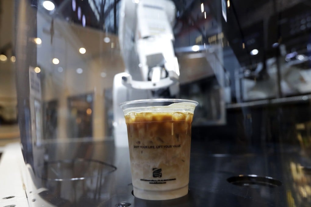 A cup of coffee is placed by a robot for a customer at a cafe in Seoul, South Korea. Photo: AP