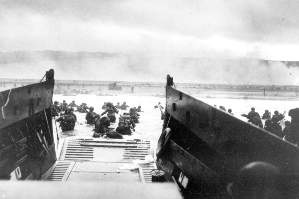 Under heavy German machine gun fire, American infantrymen wade ashore off the ramp of a landing craft at Normandy. File photo: AP