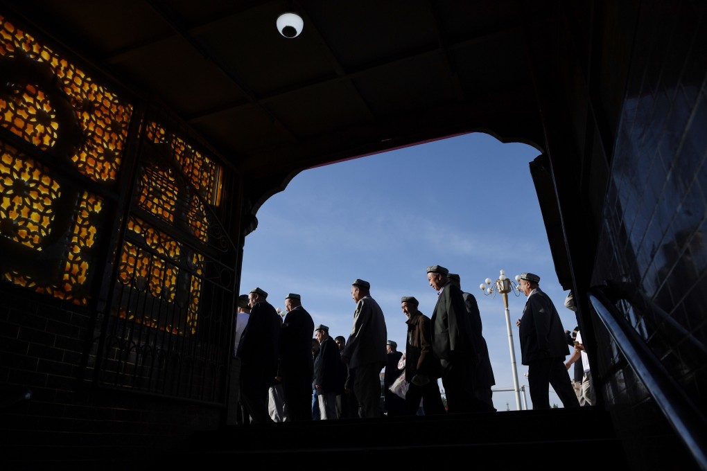 Worshippers leave a mosque in Kashgar after prayers on Wednesday. Photo: AFP