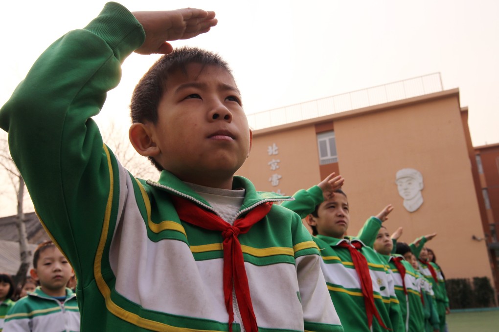 Pupils salute the Chinese national flag at Beijing Leifeng Primary School. Photo: Simon Song