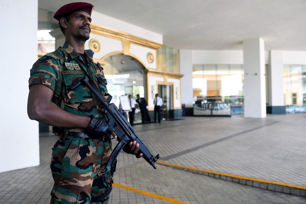 A Sri Lankan soldier stands guard at the entrance of the Cinnamon Grand hotel lobby in Colombo. Photo: AFP