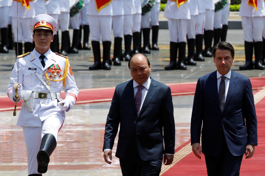Italy’s Prime Minister Giuseppe Conte (right) reviews the guard of honour with his Vietnamese counterpart Nguyen Xuan Phuc during a welcoming ceremony at the Presidential Palace in Hanoi. Photo: Reuters
