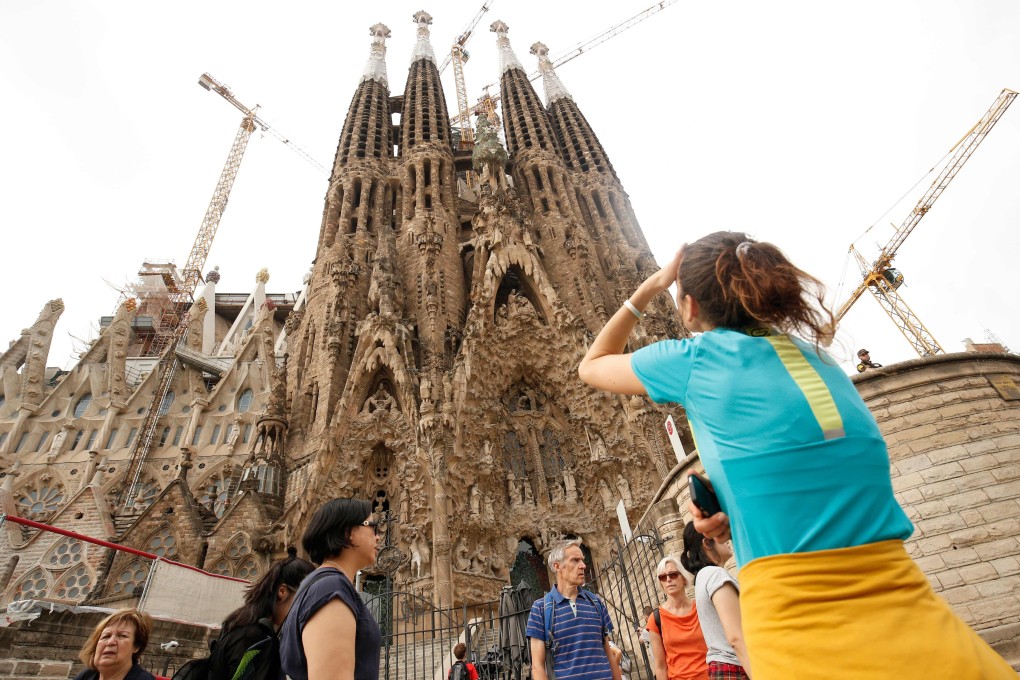 Tourists outside the Sagrada Familia, which was closed for visits during a general strike in Barcelona in October 2017. Photo: AFP
